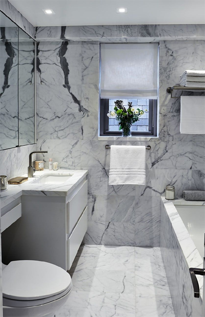Veined marble tiled bathroom: